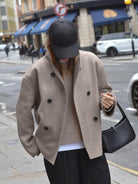 Black Charlene double-breasted peacoat with stand collar by Lumina Wear, showcasing classic style and tailored fit.