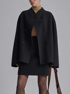 Black Charlene double-breasted peacoat with stand collar by Lumina Wear, shown on a hanger with front buttons and tailored fit.