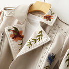 Women's leather jacket by Lumina Wear featuring floral embroidery, silver studs, and edgy design details.