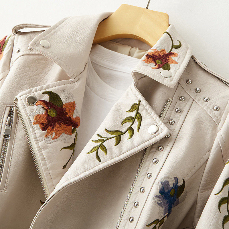 Women's leather jacket by Lumina Wear featuring floral embroidery, silver studs, and edgy design details.
