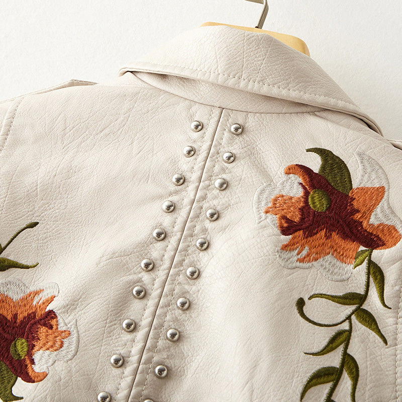 Women's leather jacket by Lumina Wear featuring floral embroidery, silver studs, and edgy design details.