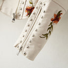 Women's leather jacket by Lumina Wear featuring floral embroidery, silver studs, and edgy style.