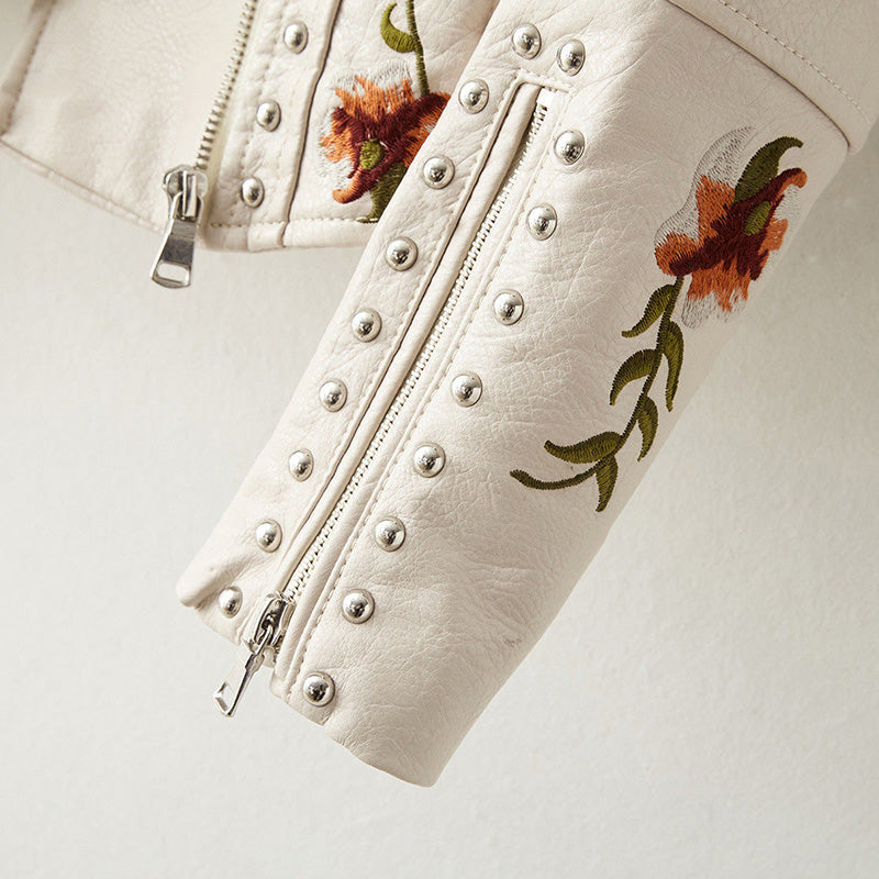 Women's leather jacket by Lumina Wear featuring floral embroidery, silver studs, and edgy style.