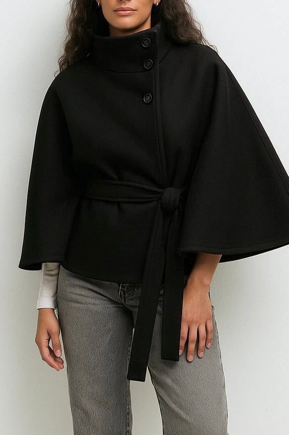 Elegant high-neck camel cape coat for women by Lumina Wear, shown hanging with a tailored silhouette and structured design.