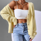 Soft white Chloé cardigan sweater with button details, worn by a woman, showcasing a cozy and stylish women's cardigan from Lumina Wear.