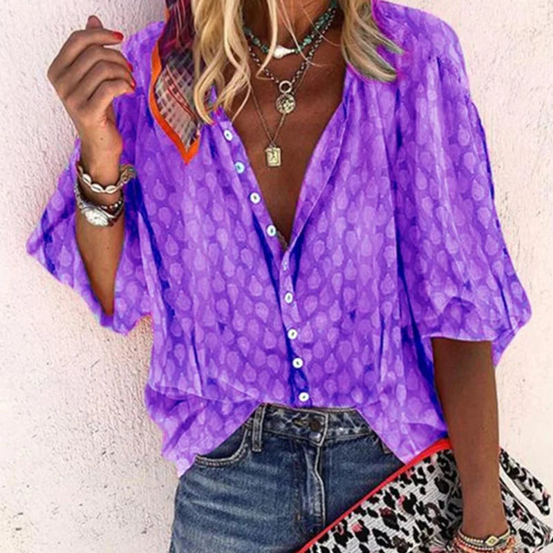 Vibrant printed casual women's blouse with button front from Lumina Wear, featuring colorful floral patterns and relaxed fit.