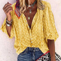 Brightly printed casual blouse with button front by Lumina Wear, styled as a comfortable and vibrant women's top.