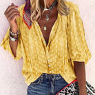 Vibrant printed women's casual blouse with button front from Lumina Wear, featuring colorful floral design and relaxed fit.