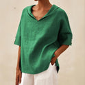Lumina Wear Clara relaxed fit V-neck top, soft fabric, casual style, shown in a neutral color on a model.