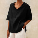 Lumina Wear Clara relaxed fit V-neck top in soft fabric, styled casually with a draped neckline and short sleeves.