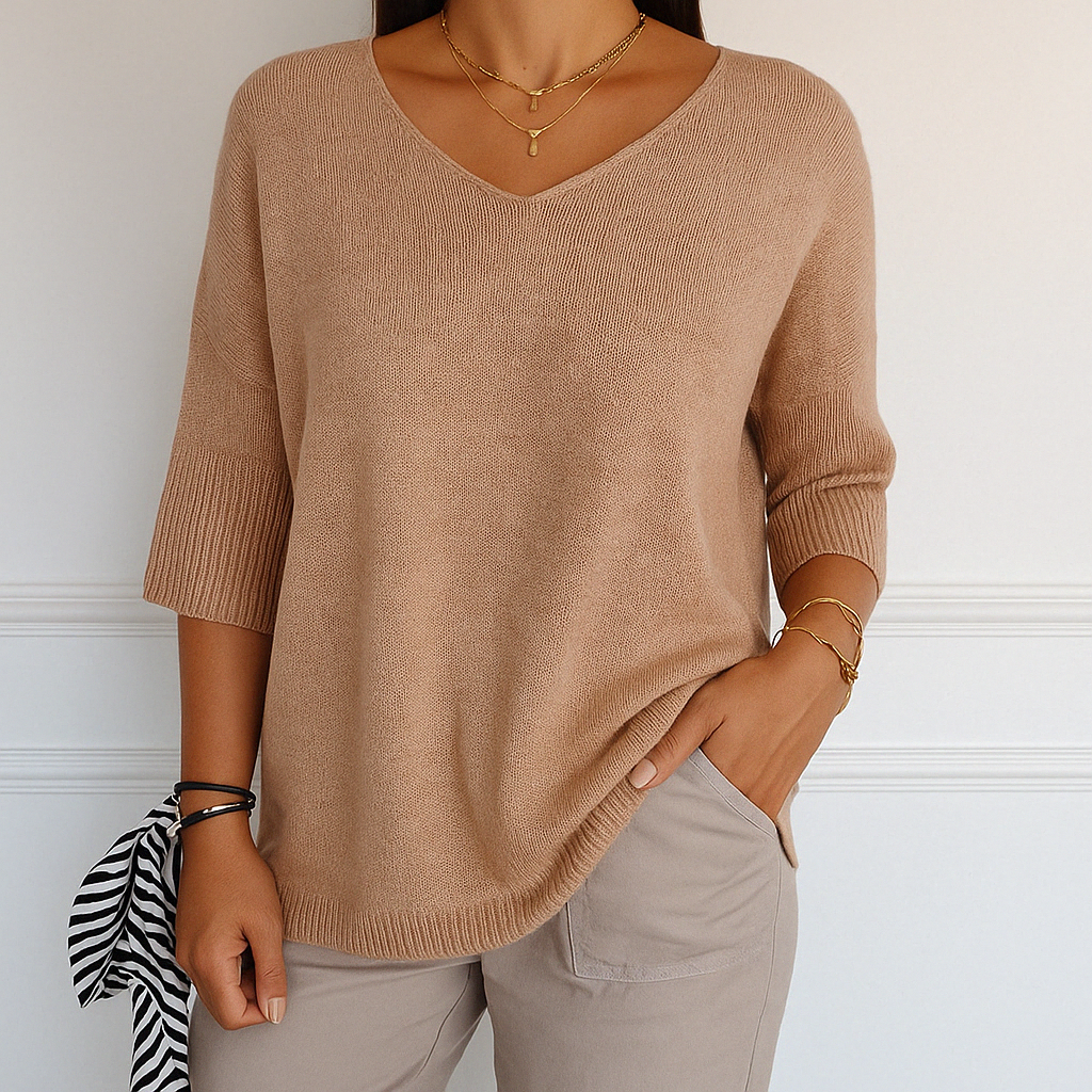 Cream-colored Lumina Wear Clara relaxed V-neck sweater with minimalist design, soft knit fabric, and comfortable fit.