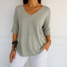 Light gray Lumina Wear Clara relaxed V-neck women's sweater with minimalist design, soft knit fabric and casual fit.