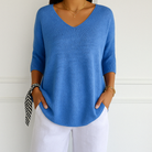 Light gray Lumina Wear Clara relaxed V-neck women's sweater with minimalist design, soft knit fabric, and comfortable fit.