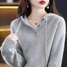 Lumina Wear Elise cozy v-neck hooded sweater with button details, soft knit fabric, and relaxed fit for comfortable casual wear.
