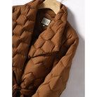 Lumina Wear Elise geometric down puffer jacket with belted waist, tailored fit, and quilted design, suitable for cold weather.