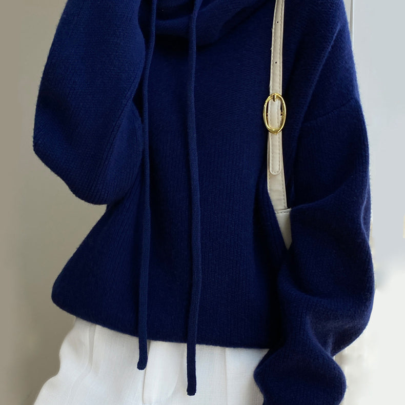 Lumina Wear Elise merino wool sweater with relaxed fit and tailored hood, featuring soft, cozy knit and casual style.