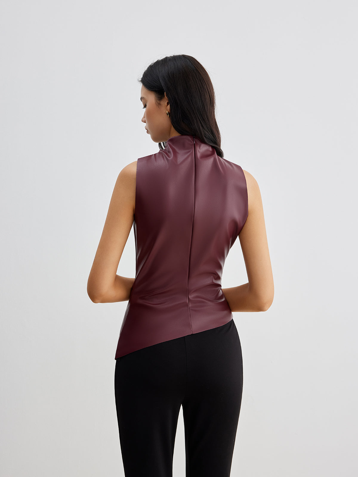 Ella sleeveless high neck tank top for women by Lumina Wear, shown in a stylish black fabric, close-up of neckline and fit.