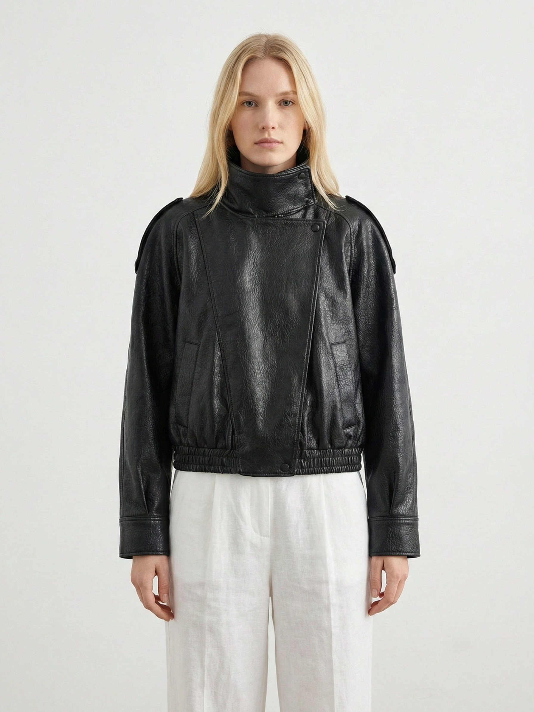Women's oversized structured faux leather jacket with high neck, in black, featuring a sleek modern design by Lumina Wear.