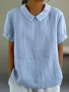 Linen blouse with Peter Pan collar from Lumina Wear, featuring a charming, feminine design and soft fabric in natural tones.