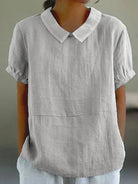 Light-colored linen blouse with a Peter Pan collar by Lumina Wear, featuring a charming and elegant design for women.
