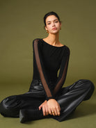 Lumina Wear Florence mesh sleeve top with relaxed fit, featuring stylish mesh sleeves and casual cotton fabric.