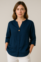 Light blue Gabrielle relaxed fit blouse with button details from Lumina Wear, featuring a casual, comfortable design.