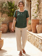 Light beige Lumina Wear relaxed linen blouse with button detail, featuring a loose fit and casual style.