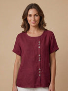 Light beige linen blouse with relaxed fit and button details from Lumina Wear's Grace collection.