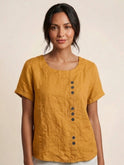 Light beige Lumina Wear Grace linen blouse with relaxed fit and button details, displayed on a neutral background.