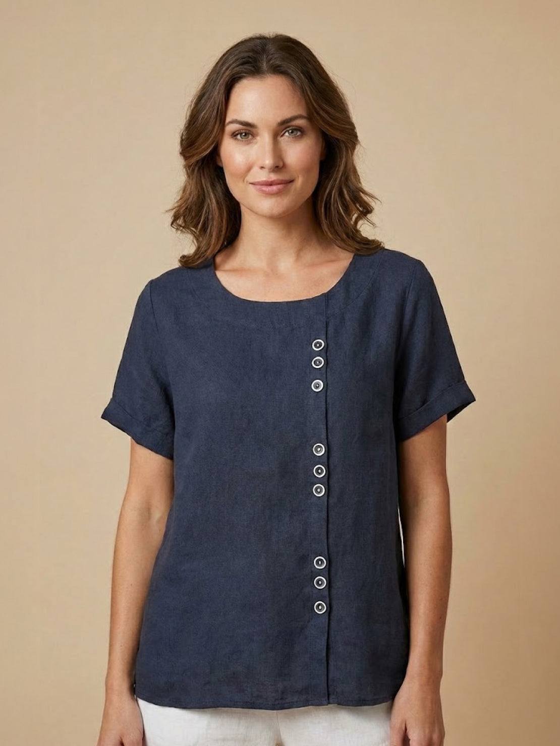 Linen blouse by Lumina Wear featuring relaxed fit, button details, and lightweight fabric in a neutral tone.