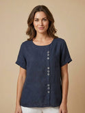 Light beige Lumina Wear Grace relaxed linen blouse with button details, featuring a casual fit and soft fabric.