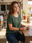 Light beige Lumina Wear Grace linen blouse with relaxed fit and button details, displayed on a hanger.