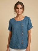 Lumina Wear Grace relaxed linen blouse with button details, showcasing a casual, flowy fit and lightweight fabric.