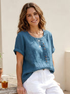 Lumina Wear Grace relaxed linen blouse with button detail, featuring a casual fit and soft fabric, perfect for everyday wear.