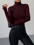 Hailey Lumina Wear sleek minimalist turtleneck top in black, designed for winter elegance, close-up of the fitted collar and smooth fabric.