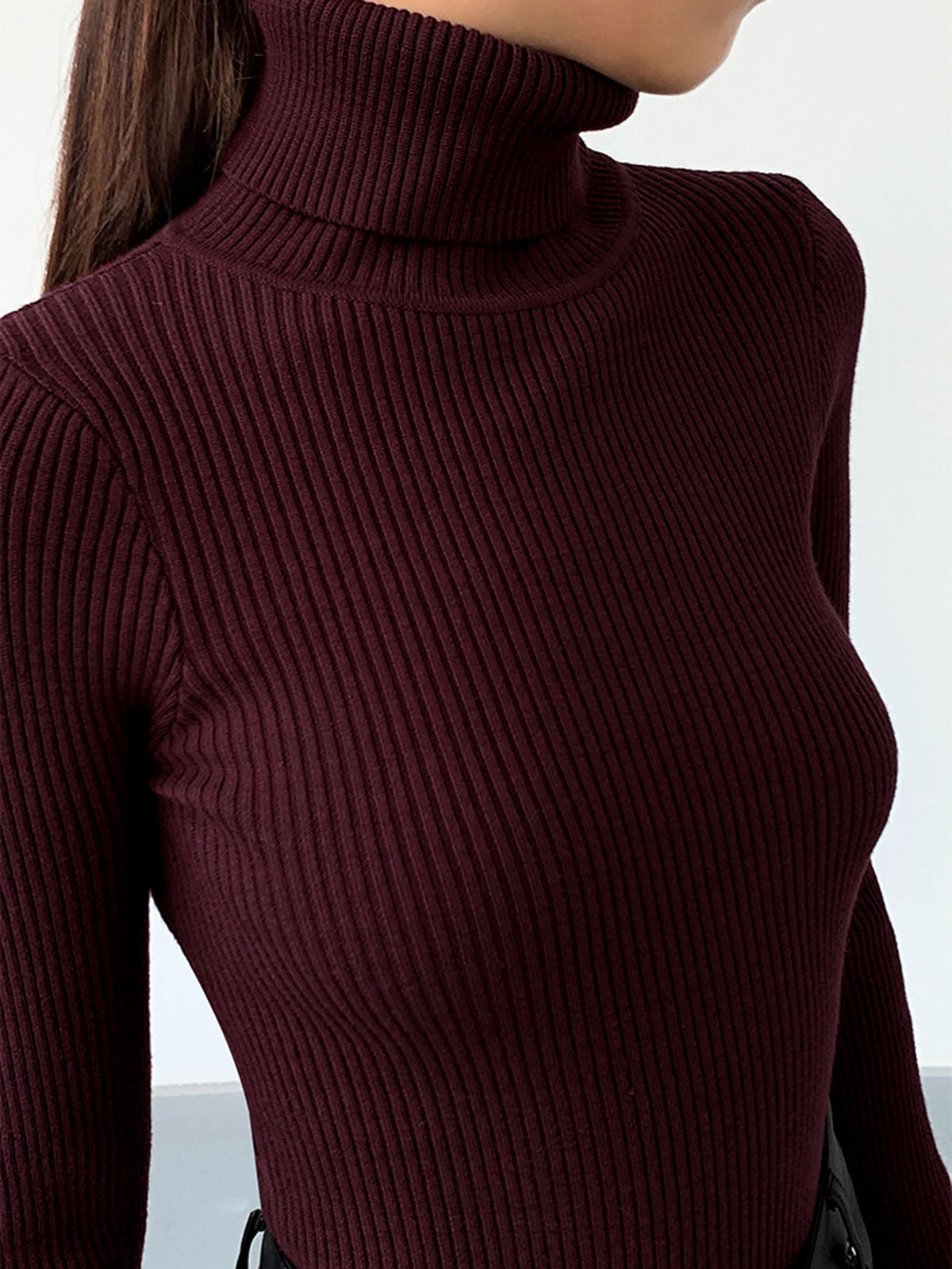 Lumina Wear Hailey sleek minimalist turtleneck top for winter, shown in close-up with smooth fabric and elegant design.