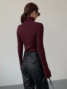 Lumina Wear Hailey sleek minimalist turtleneck top in winter black, showing a close-up of the fitted, smooth fabric and high neckline.