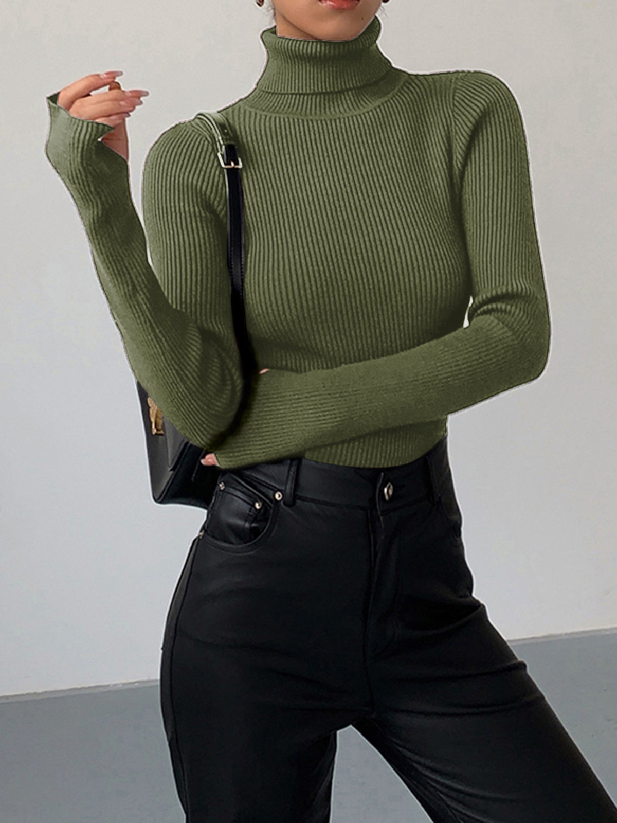Lumina Wear Hailey minimalist black turtleneck top, sleek winter fashion, close-up of the fitted collar and smooth fabric.