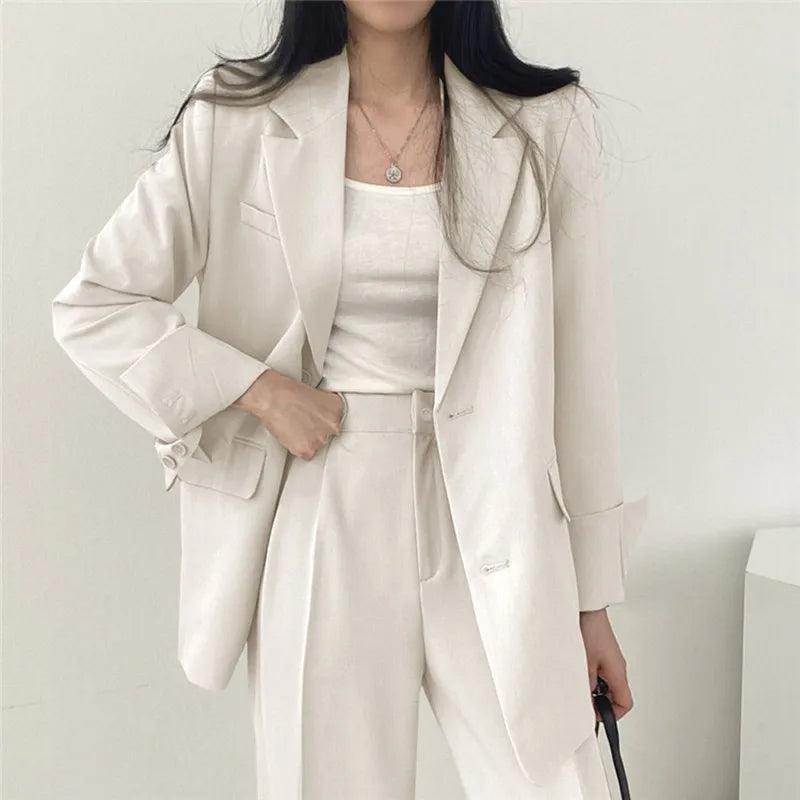 Lumina Wear Hailey tailored blazer and high-waisted trousers suit set, stylish formal outfit for women, in a professional setting.