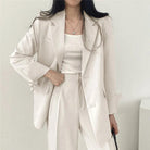Lumina Wear Hailey tailored blazer and high-waisted trousers suit set, stylish formal outfit for women, in a professional setting.