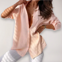Light beige Lumina Wear Hazel relaxed blouse with button front and roll-up sleeves, displayed on a neutral background.