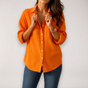 Light blue Lumina Wear Hazel relaxed blouse with button front and roll-up sleeves, casual and comfortable for everyday wear.