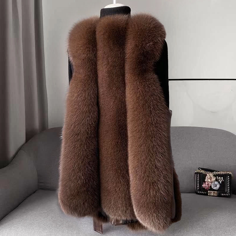 Isabella Lumina faux fur vest with leather trim, belt detail, and sleek silhouette, styled with a modern, sophisticated look.