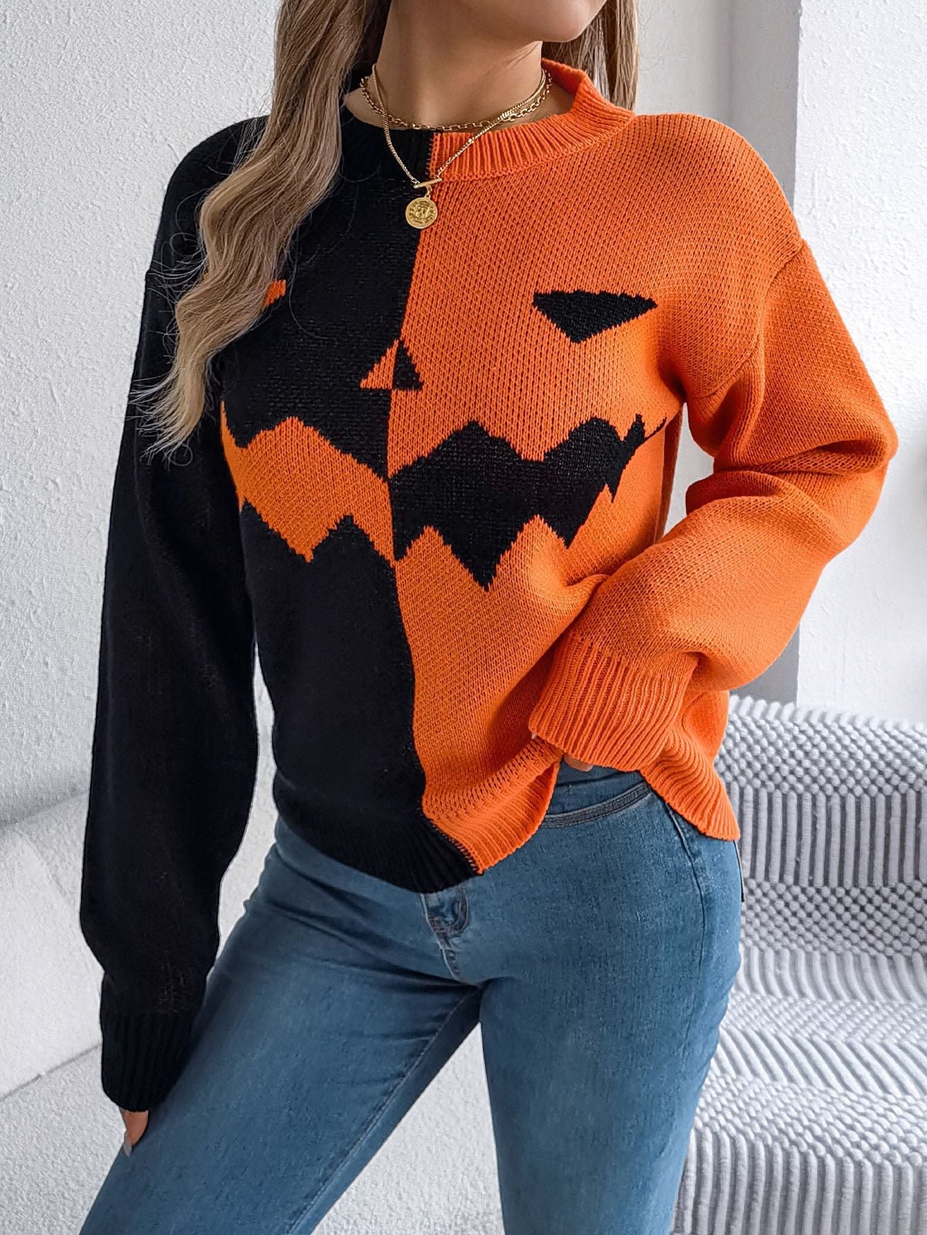 Lumina Wear women's knit pullover featuring bold orange and black colors with a Jack-o'-Lantern design.