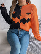 Lumina Wear women's knit pullover in bold orange and black with a Jack-o'-Lantern design, perfect for fall and Halloween.
