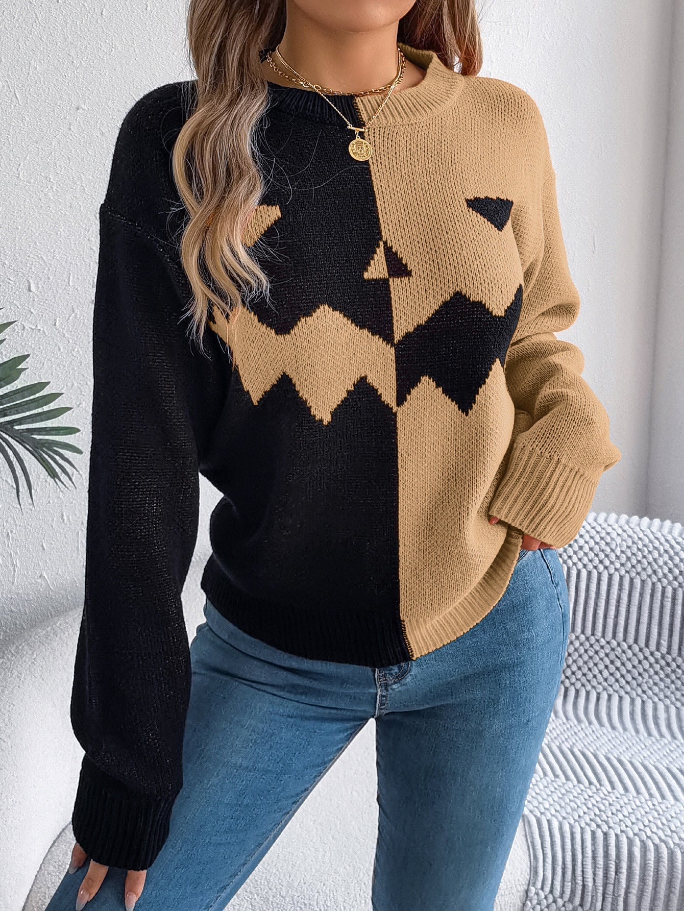 Women's knit pullover by Lumina Wear featuring bold orange and black colors with a Jack-o'-Lantern design.
