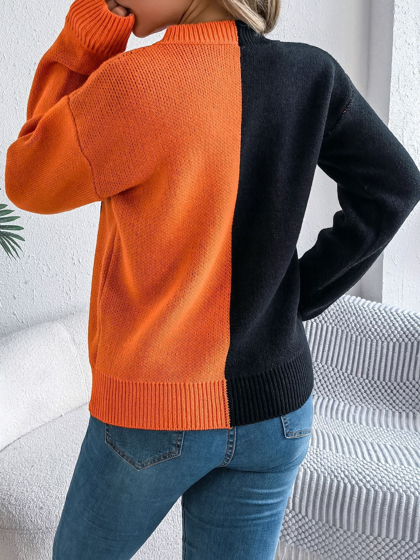 Lumina Wear Isabella women's knit pullover featuring bold orange and black jack-o'-lantern design, cozy Halloween-themed sweater.