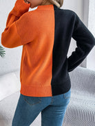 Lumina Wear Isabella women's knit pullover featuring bold orange and black jack-o'-lantern design, cozy Halloween-themed sweater.