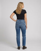 Distressed mid-rise straight leg jeans with frayed hem from Lumina Wear's Isabella collection, shown on a model.
