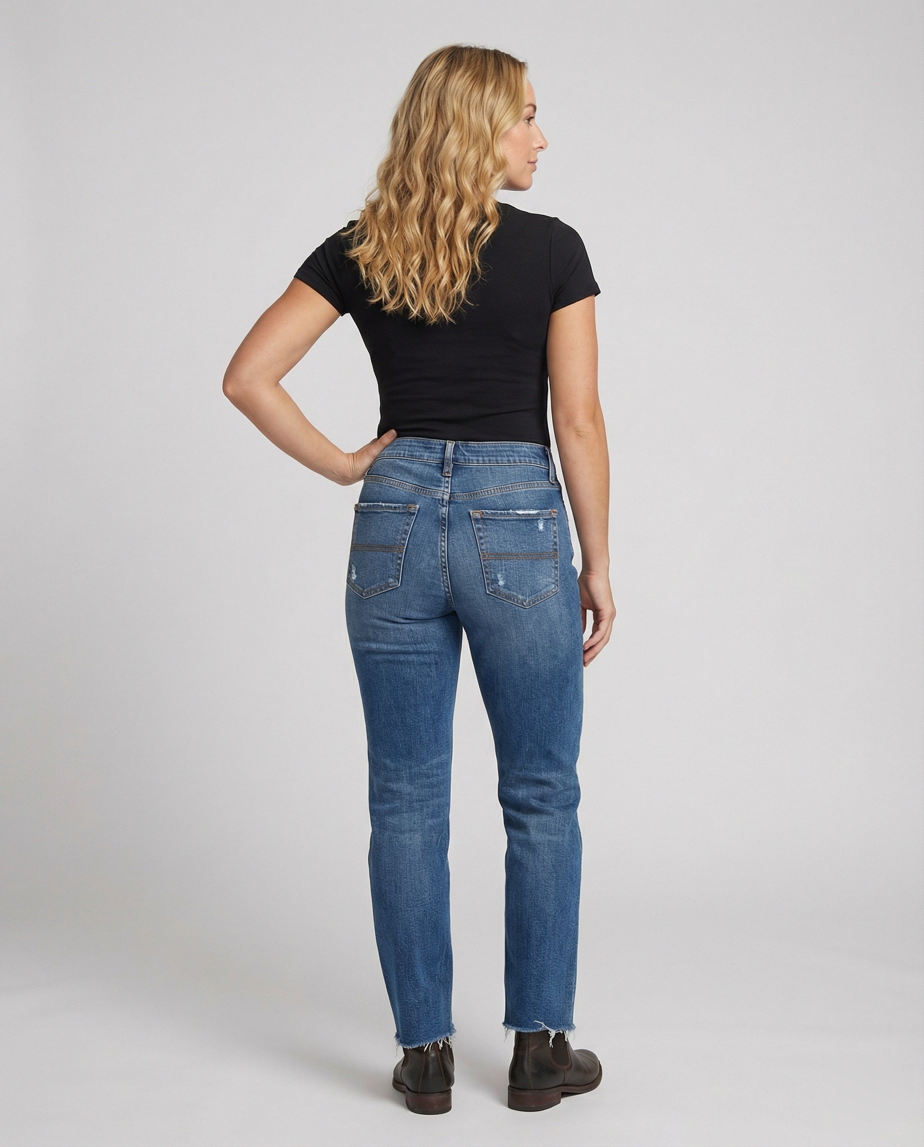 Distressed mid-rise straight leg jeans with frayed hem from Lumina Wear's Isabella collection, shown on a model.